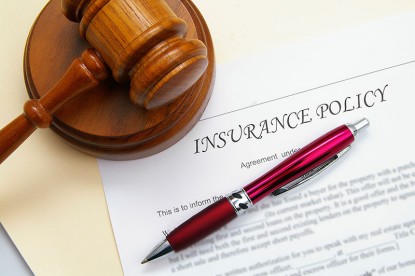 Insurance policy and legal gavel